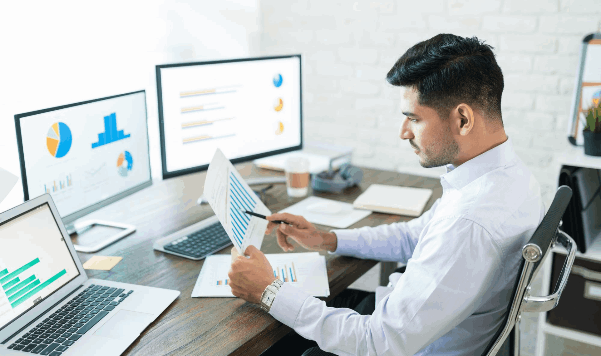 SEO analyst reviewing performance metrics on multiple monitors with charts and graphs.