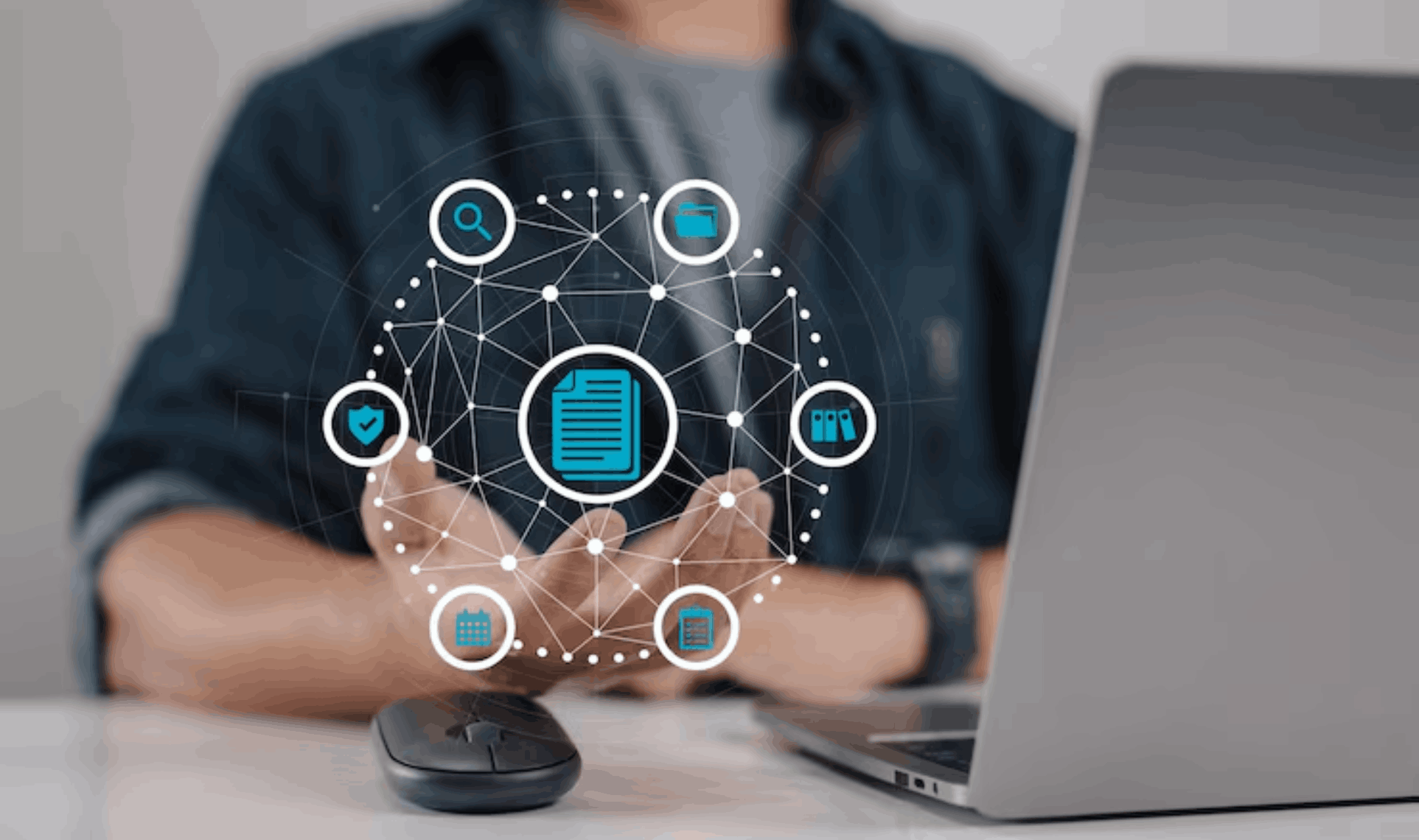 A person working at a laptop with a digital networking overlay showcasing icons for Vulnerability & Patch Management.
