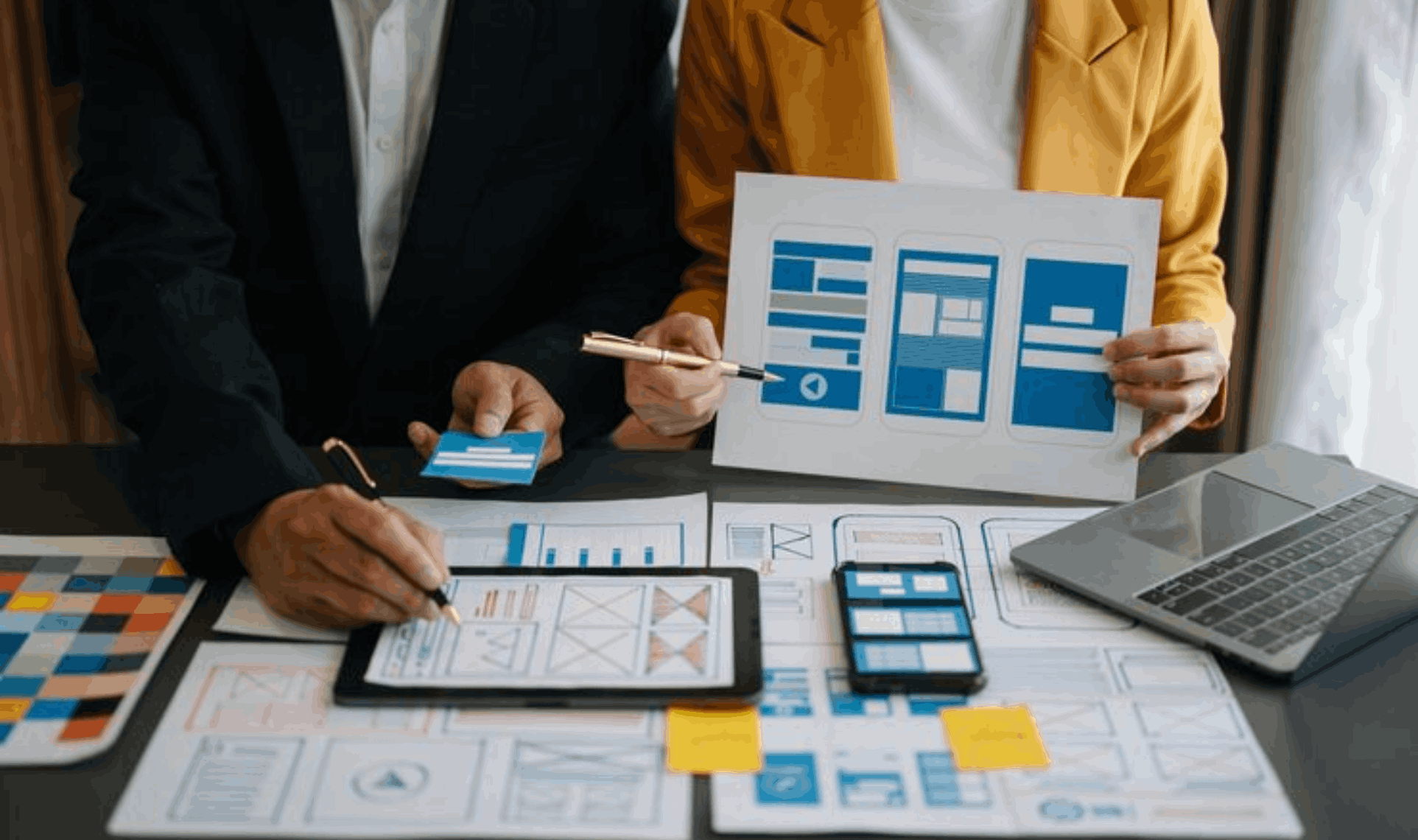 Four professionals collaborating in a modern office lounge