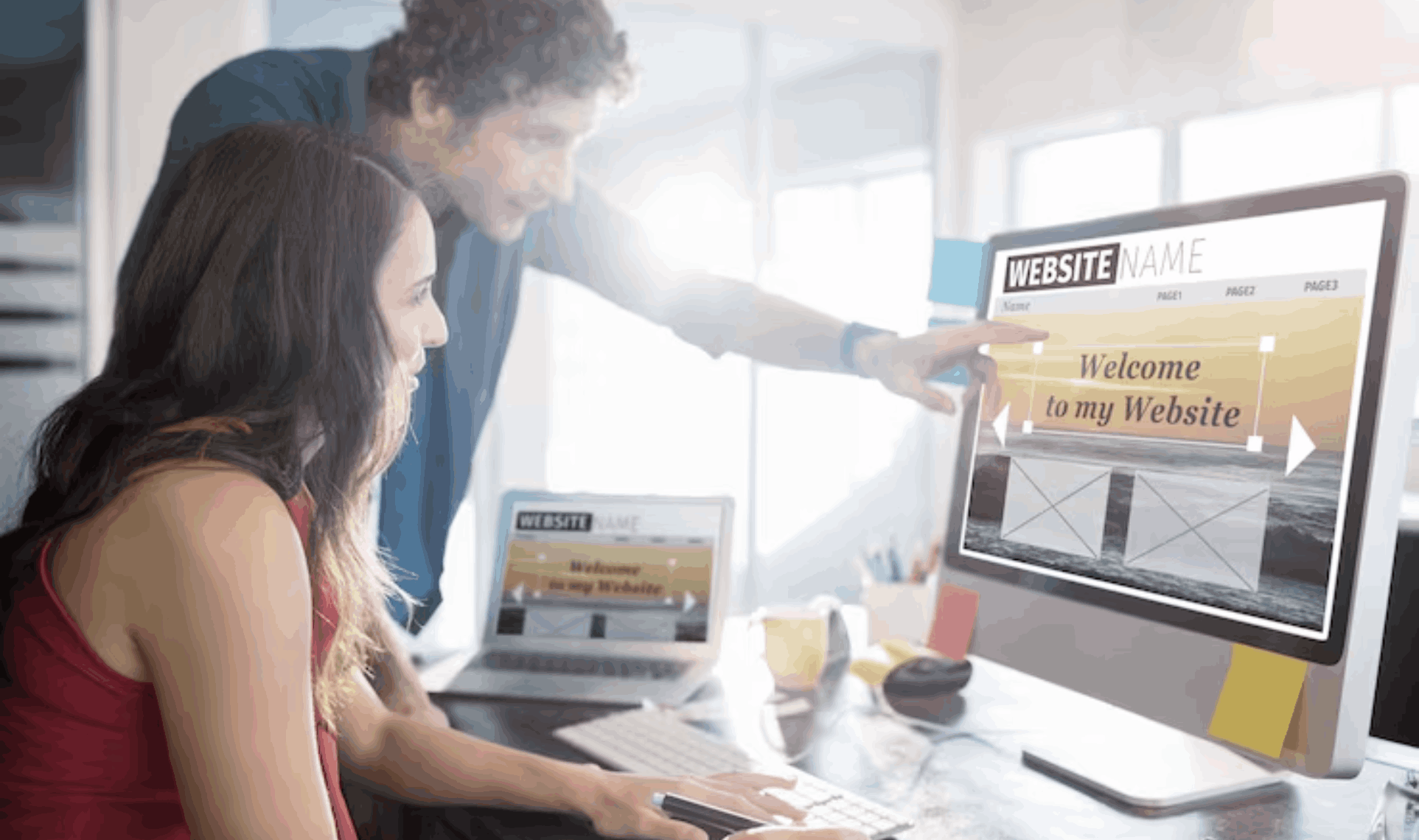 Two people collaborating on a Website Redesign & Optimization project, reviewing and updating a website layout on a desktop screen.